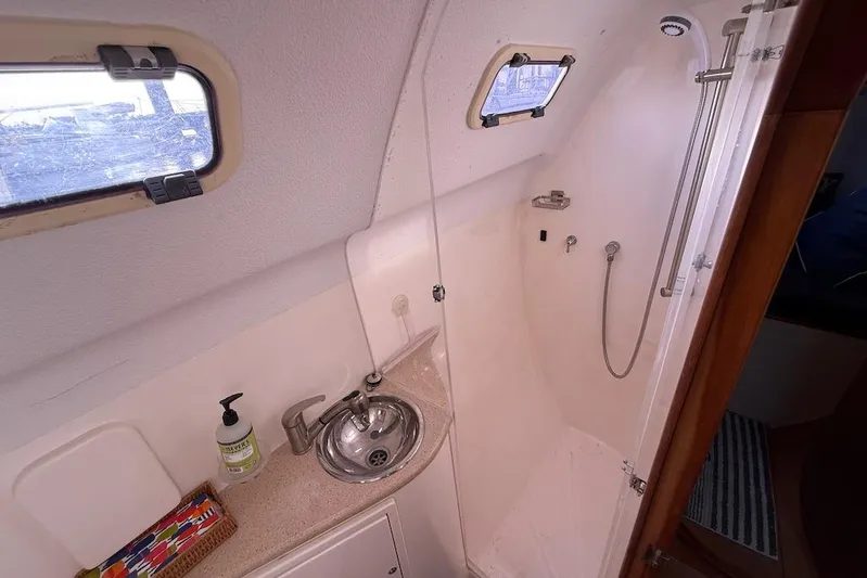 Zimbini Yacht Photos Pics Bathroom interior of 2006 Island Spirit 401 yacht with sink and shower.
