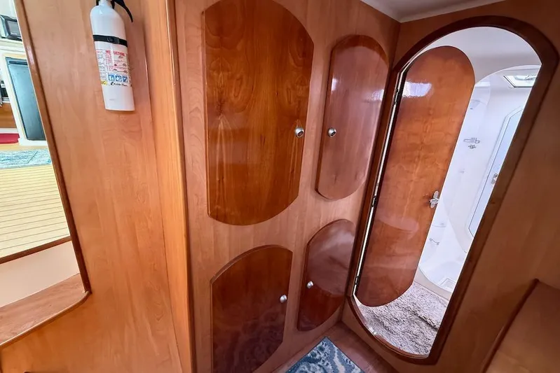 Zimbini Yacht Photos Pics Interior of 2006 Island Spirit 401 yacht with wooden cabinets and a fire extinguisher.