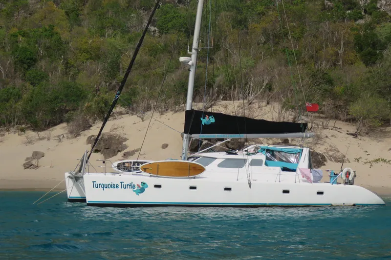 Turquoise Turtle Yacht Photos Pics Catamaran "Turquoise Turtle" anchored near a sandy beach, Voyage 500 model, 2001.