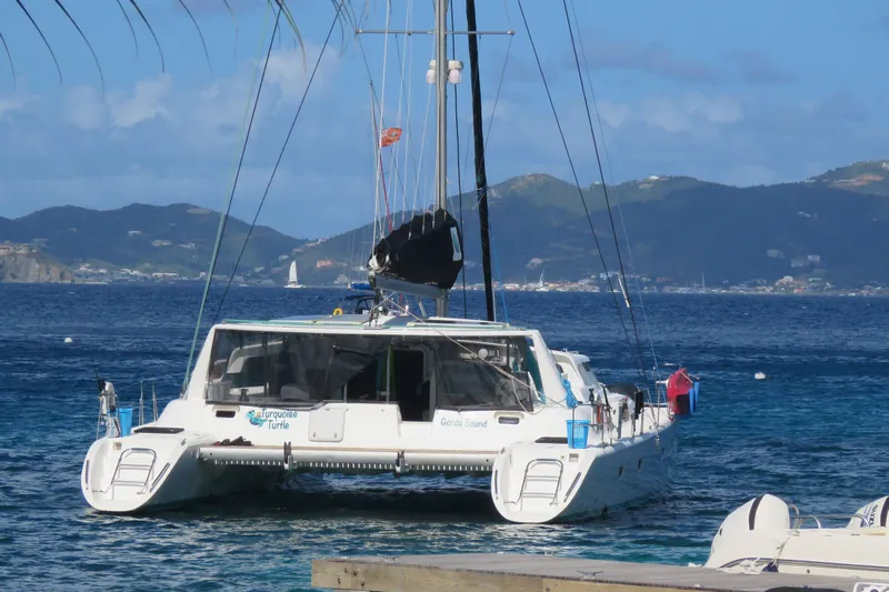 Turquoise Turtle Yacht Photos Pics Catamaran Voyage 500, 2001 model, anchored in scenic tropical waters.