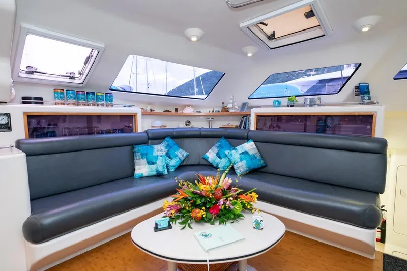 Turquoise Turtle Yacht Photos Pics Luxurious interior of a 2001 Voyage 500 yacht with modern seating and vibrant decor.