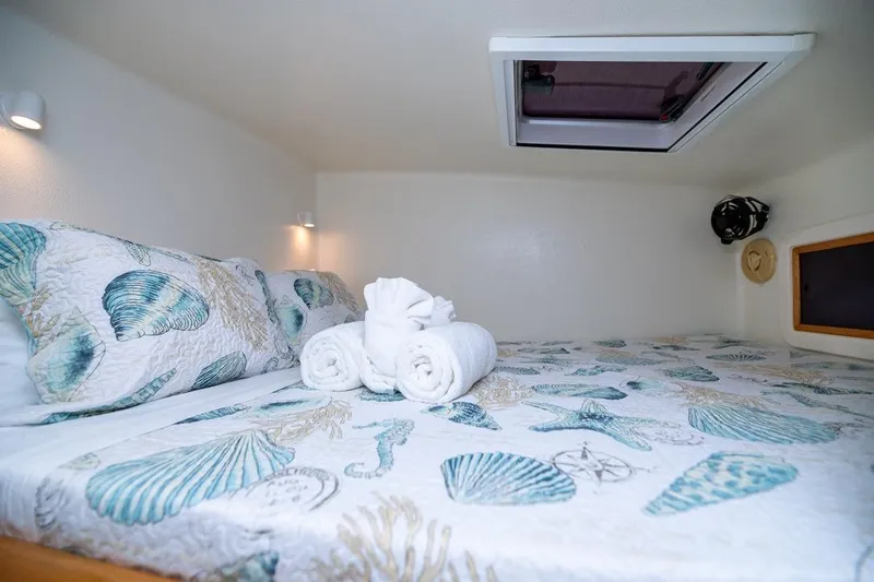 Turquoise Turtle Yacht Photos Pics Cozy cabin bed in 2001 Voyage 500 yacht with seashell-themed bedding.