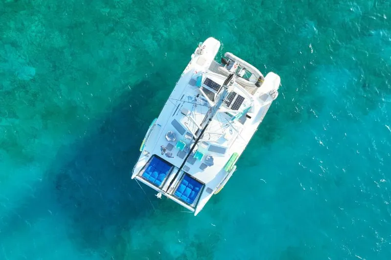 Turquoise Turtle Yacht Photos Pics Aerial view of 2001 Voyage 500 catamaran on clear turquoise water.