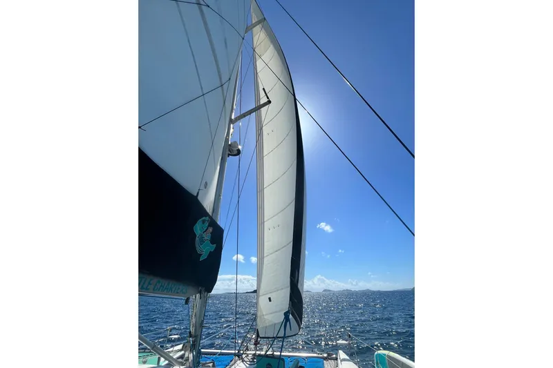 Turquoise Turtle Yacht Photos Pics Sailing on a 2001 Voyage 500 catamaran under clear blue skies.