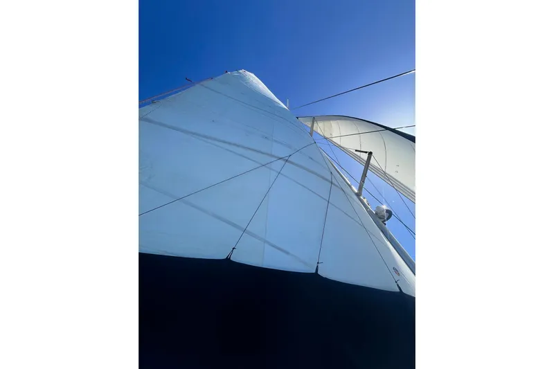 Turquoise Turtle Yacht Photos Pics Sail of a 2001 Voyage 500 yacht against a clear blue sky.