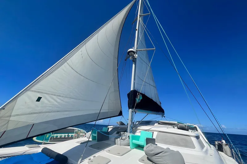 Turquoise Turtle Yacht Photos Pics Sailing on a 2001 Voyage 500 catamaran under clear blue skies.