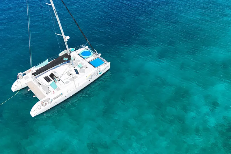 Turquoise Turtle Yacht Photos Pics Aerial view of 2001 Voyage 500 catamaran on clear turquoise water.
