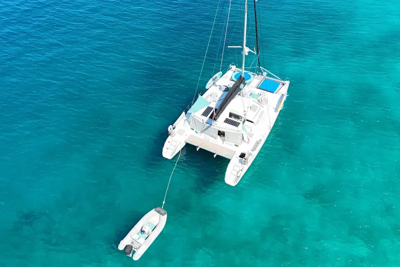 Turquoise Turtle Yacht Photos Pics Aerial view of 2001 Voyage 500 catamaran on clear turquoise water.