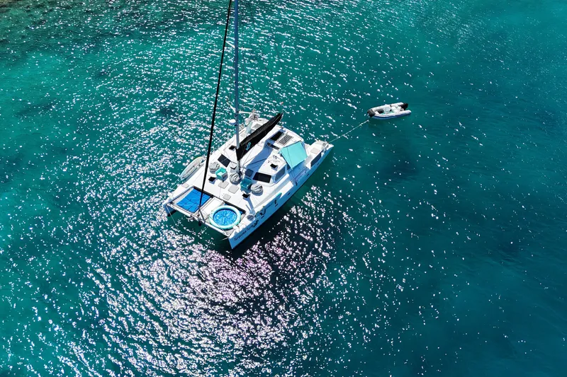 Turquoise Turtle Yacht Photos Pics Aerial view of 2001 Voyage 500 catamaran on sparkling turquoise water.