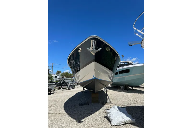  Yacht Photos Pics 2021 Formula 350 Crossover Bowrider OB on dry dock under clear blue sky.