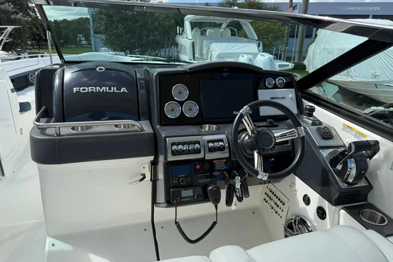  Yacht Photos Pics 2021 Formula 350 Crossover Bowrider OB cockpit with steering wheel and control panel.