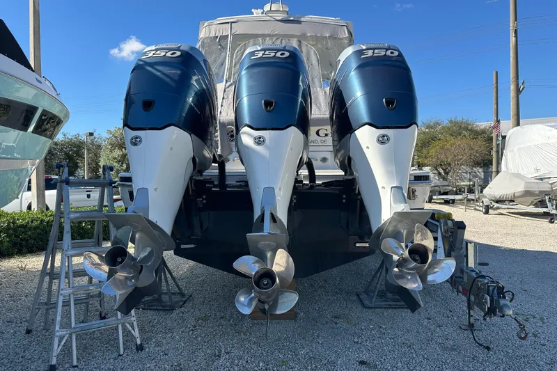  Yacht Photos Pics 2021 Formula 350 Crossover Bowrider OB with triple outboard engines, parked outdoors.