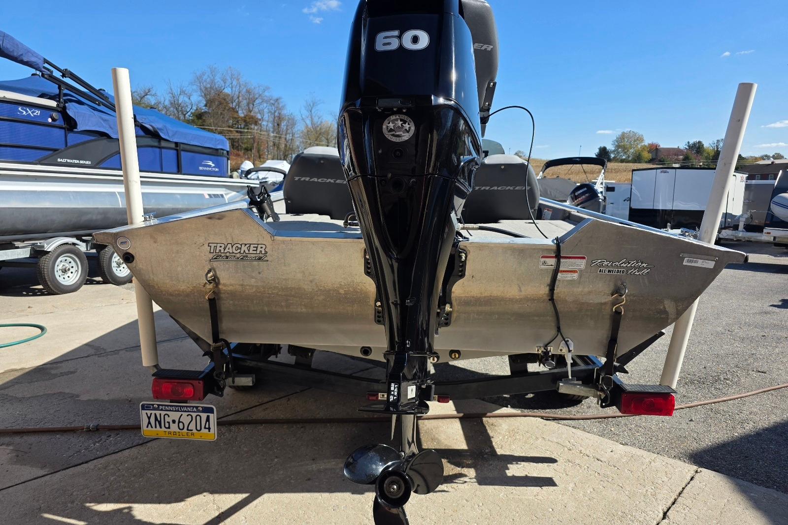 2010 Bass Tracker Pro Crappie 175 boat with 60 HP motor, parked on trailer.
