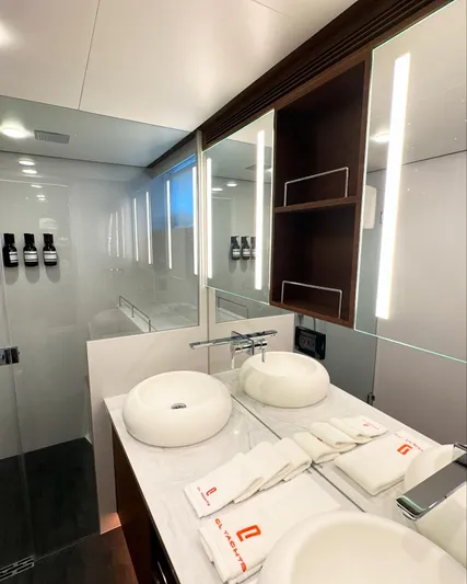  Yacht Photos Pics Luxurious bathroom in 2023 CL Yachts CLB65, featuring dual sinks and modern lighting.