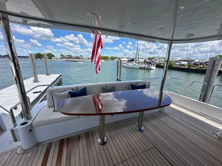  Yacht Photos Pics 2023 CL Yachts CLB65 yacht deck with elegant seating and waterfront view.