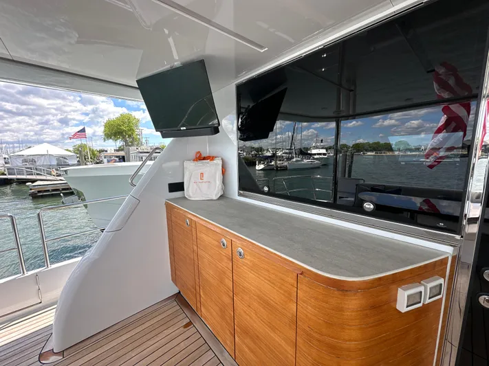  Yacht Photos Pics 2023 CL Yachts CLB65 yacht deck with wooden cabinetry and waterfront view.