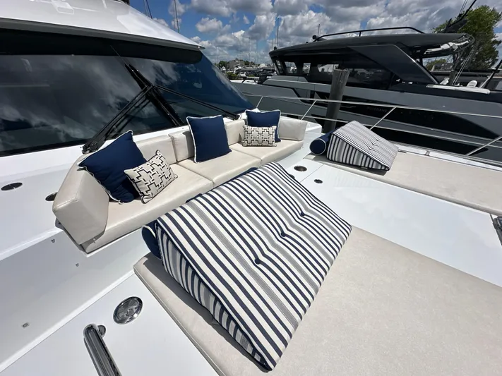  Yacht Photos Pics 2023 CL Yachts CLB65 luxury yacht with stylish outdoor seating and striped cushions.