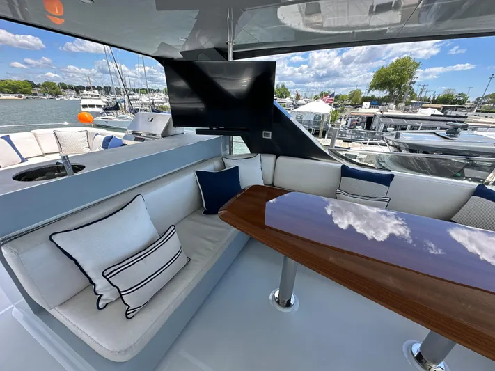  Yacht Photos Pics Luxurious seating area on 2023 CL Yachts CLB65 with TV and marina view.