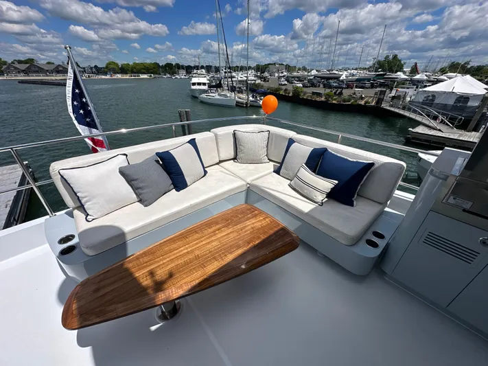  Yacht Photos Pics Luxurious 2023 CL Yachts CLB65 yacht deck with elegant seating and scenic marina view.
