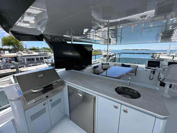  Yacht Photos Pics Luxurious 2023 CL Yachts CLB65 yacht deck with modern amenities and scenic marina view.