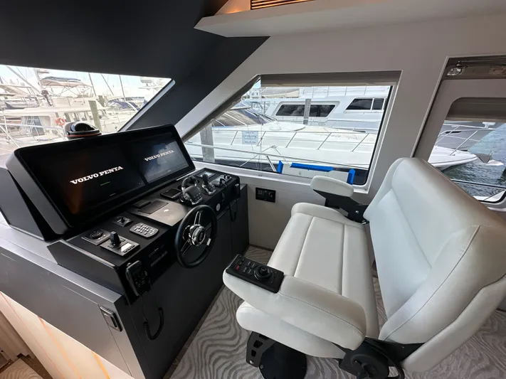  Yacht Photos Pics Helm station of 2023 CL Yachts CLB65 with modern controls and comfortable seating.