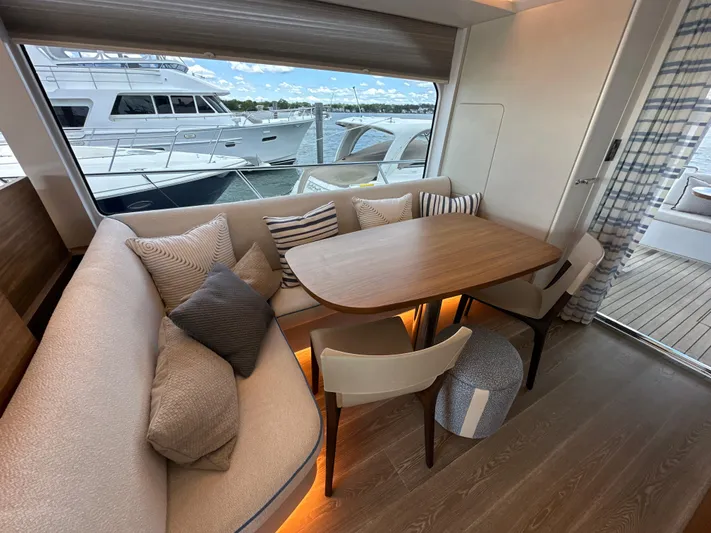  Yacht Photos Pics 2023 CL Yachts CLB65 interior with elegant dining area and scenic window view.