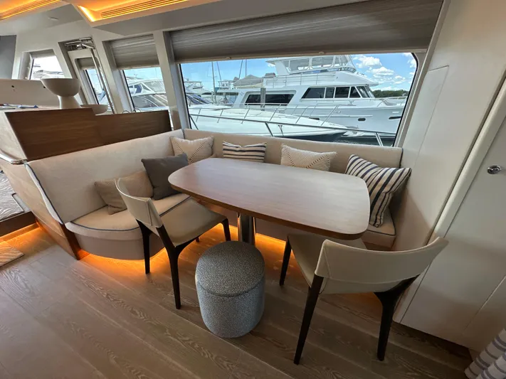  Yacht Photos Pics Luxurious 2023 CL Yachts CLB65 interior with elegant dining area and marina view.