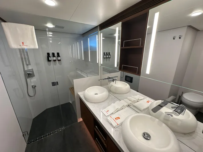  Yacht Photos Pics Luxurious bathroom in 2023 CL Yachts CLB65, featuring dual sinks and modern shower.