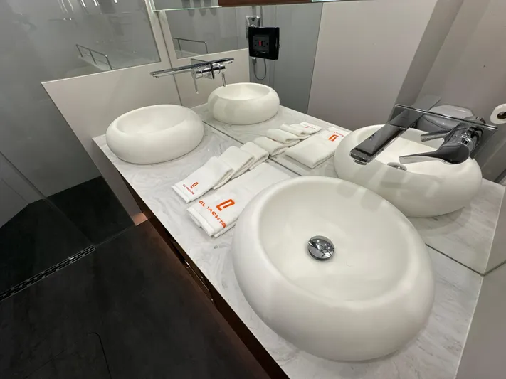  Yacht Photos Pics Luxurious bathroom in 2023 CL Yachts CLB65 with modern sinks and elegant fixtures.