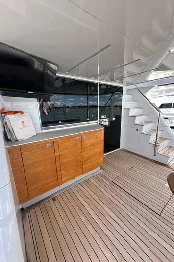  Yacht Photos Pics 2023 CL Yachts CLB65 yacht interior with wooden cabinetry and stairs, showcasing luxury design.