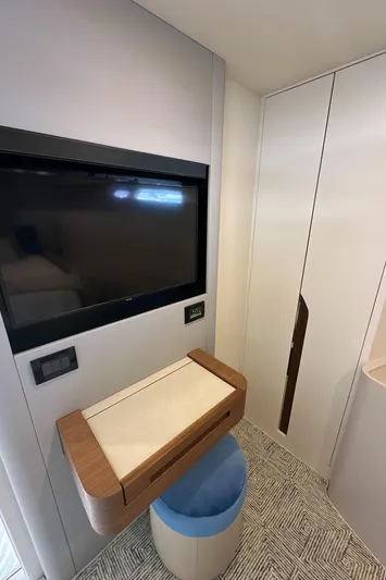  Yacht Photos Pics 2023 CL Yachts CLB65 interior with TV, modern desk, and storage.