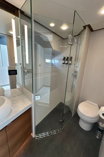  Yacht Photos Pics Modern bathroom in 2023 CL Yachts CLB65, featuring glass shower and sleek fixtures.