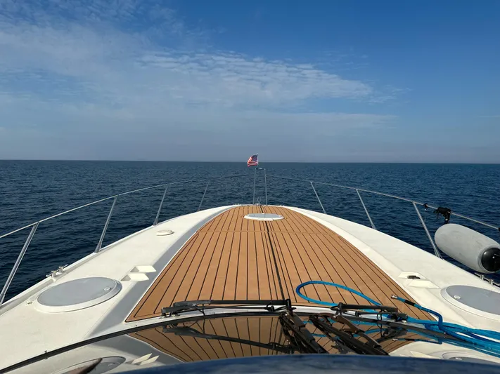  Yacht Photos Pics Bow view of 1997 Sunseeker Camargue yacht cruising on open sea under clear skies.