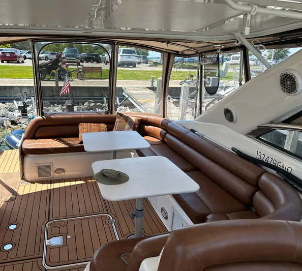  Yacht Photos Pics 1997 Sunseeker Camargue yacht interior with brown seating and white tables.