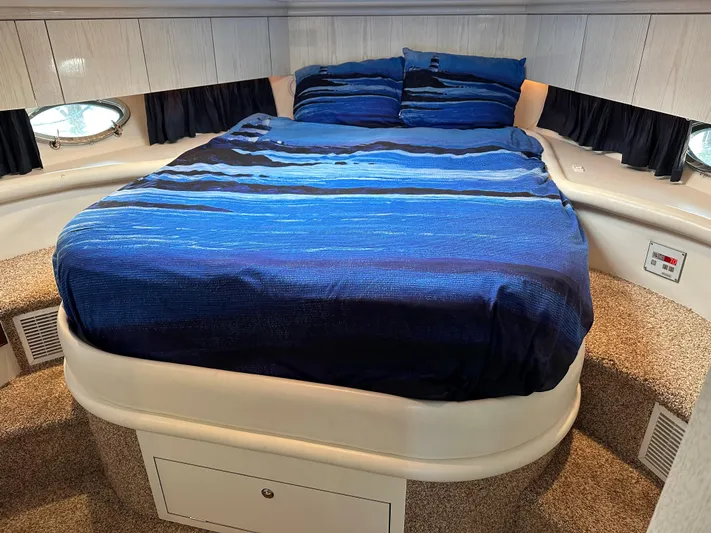  Yacht Photos Pics Luxurious 1997 Sunseeker Camargue yacht bedroom with blue bedding and elegant design.
