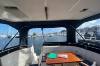 Interior view of 1999 Nimbus 380 Carisma yacht with marina backdrop.