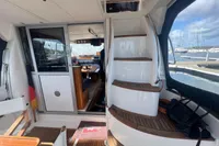 Interior of 1999 Nimbus 380 Carisma yacht with wooden stairs and marina view.