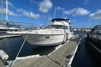 Nimbus 380 Carisma 1999 yacht docked at marina under blue sky.