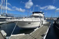 Nimbus 380 Carisma 1999 yacht docked at marina under blue sky.