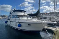 Nimbus 380 Carisma 1999 yacht docked at marina under blue sky.