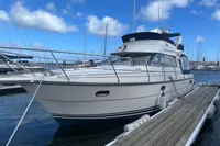 1999 Nimbus 380 Carisma yacht docked at marina under blue sky.
