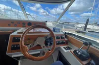 Cockpit of 1999 Nimbus 380 Carisma boat with wooden steering wheel and control panel.
