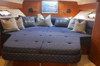 Luxurious cabin interior of 1999 Nimbus 380 Carisma with plush bedding and nautical decor.
