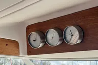 Gauges on 1999 Nimbus 380 Carisma boat dashboard, featuring wood paneling.