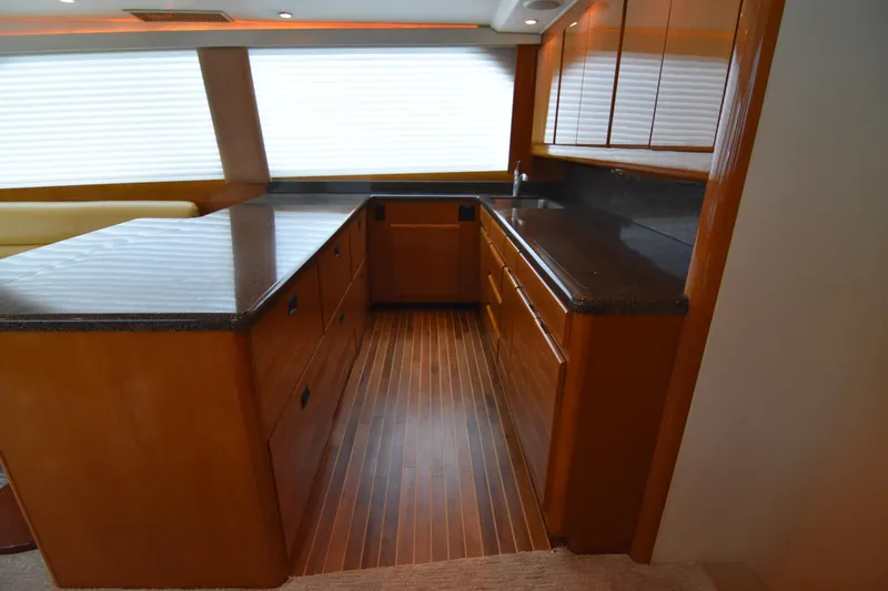 Legacy Yacht Photos Pics Luxurious kitchen interior of 1999 Viking 58 Convertible yacht with wooden cabinetry.