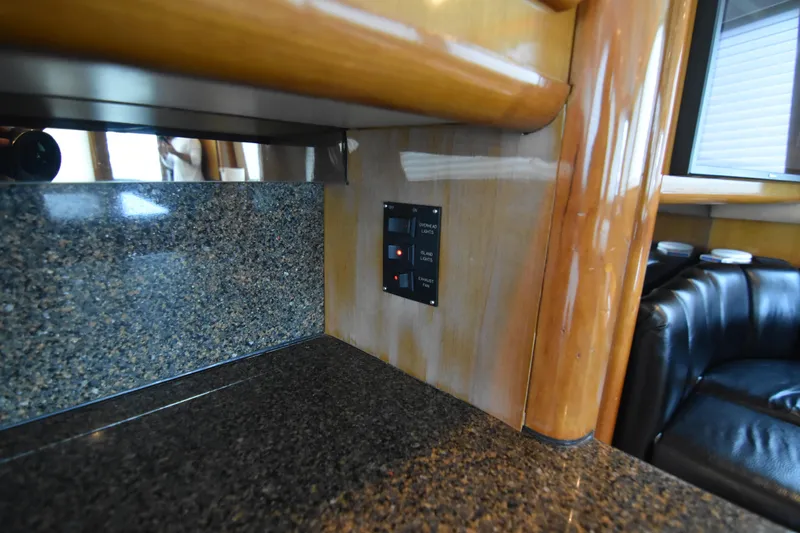 Legacy Yacht Photos Pics Interior of 1999 Viking 58 Convertible yacht with granite countertop and control panel.