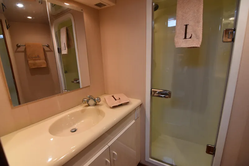 Legacy Yacht Photos Pics Bathroom interior of 1999 Viking 58 Convertible yacht with shower and sink.
