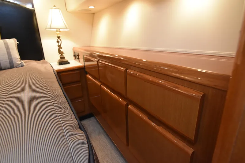 Legacy Yacht Photos Pics Luxurious interior of 1999 Viking 58 Convertible yacht with elegant wood cabinetry and ambient lighting.