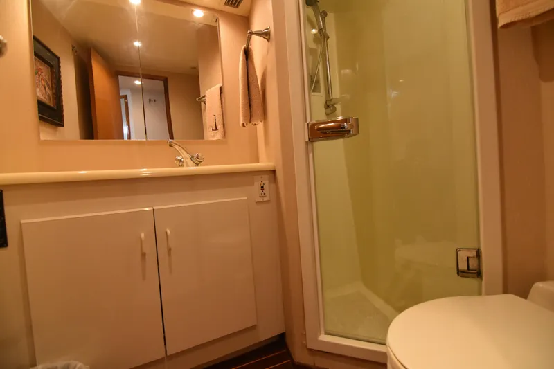 Legacy Yacht Photos Pics Bathroom interior of 1999 Viking 58 Convertible yacht with shower and vanity.
