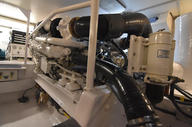 Legacy Yacht Photos Pics Engine room of a 1999 Viking 58 Convertible yacht, showcasing mechanical components.